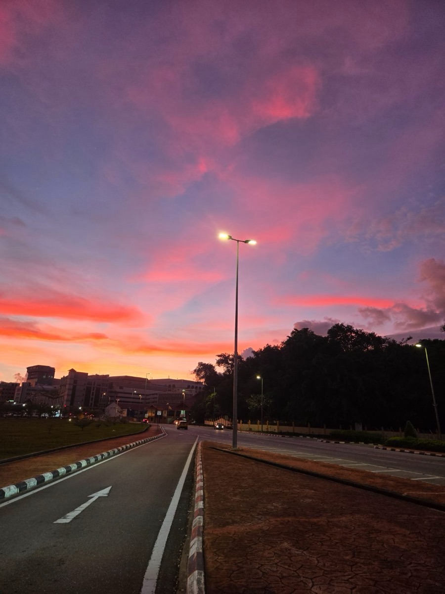 A road at sunset, vivid pink sky